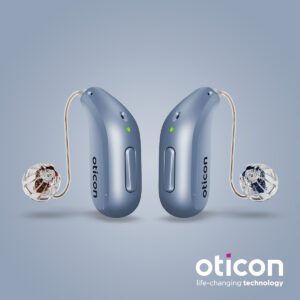 Two blue oticon hearing aids with a green light indicating they're on.